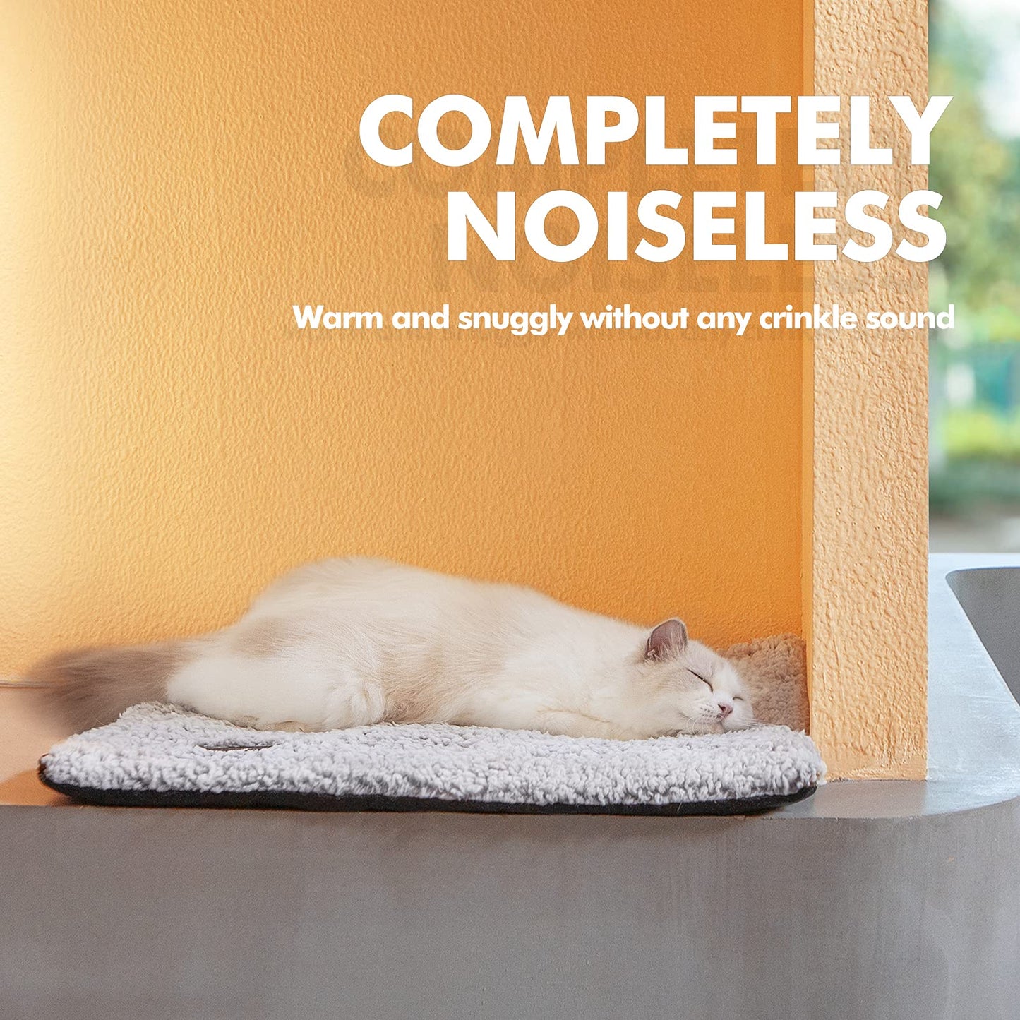 Black and white cat lying on a self-warming grey pet bed with ultra-soft fleece surface