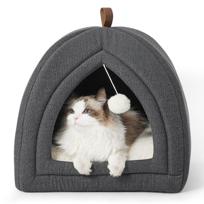 The Maine Coon cat is lying in the grey foldable cat cave, with the plush toy ball swinging back and forth.
