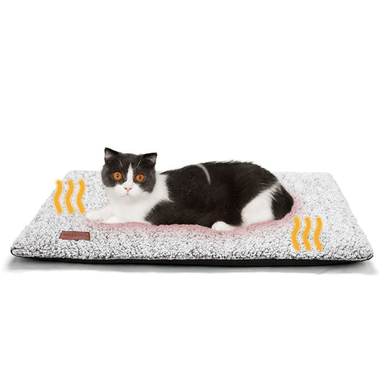 Black and white cat lying on a self-warming grey pet bed with ultra-soft fleece surface